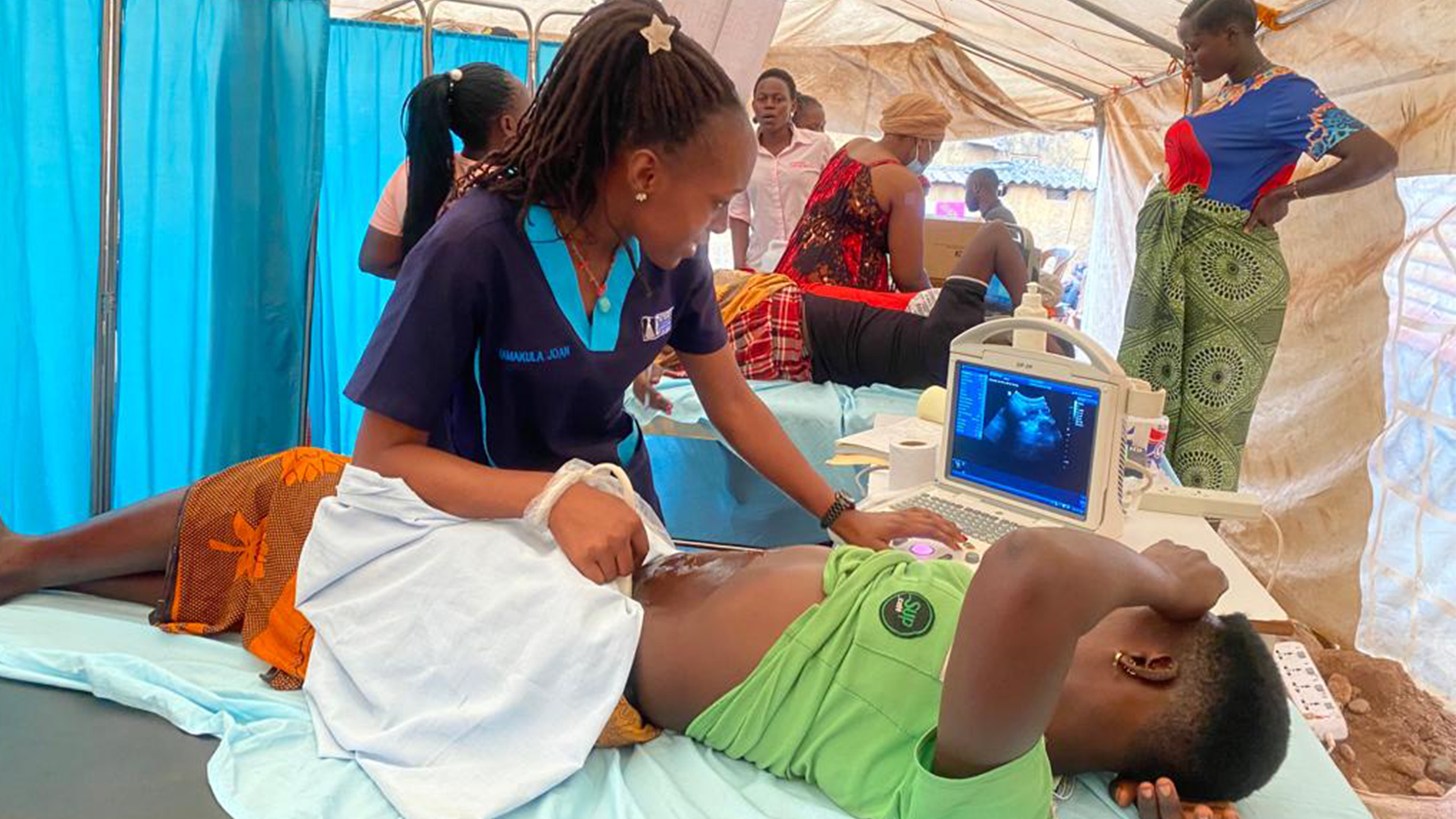 Pregnant woman receiving an ultrasound as staff look on