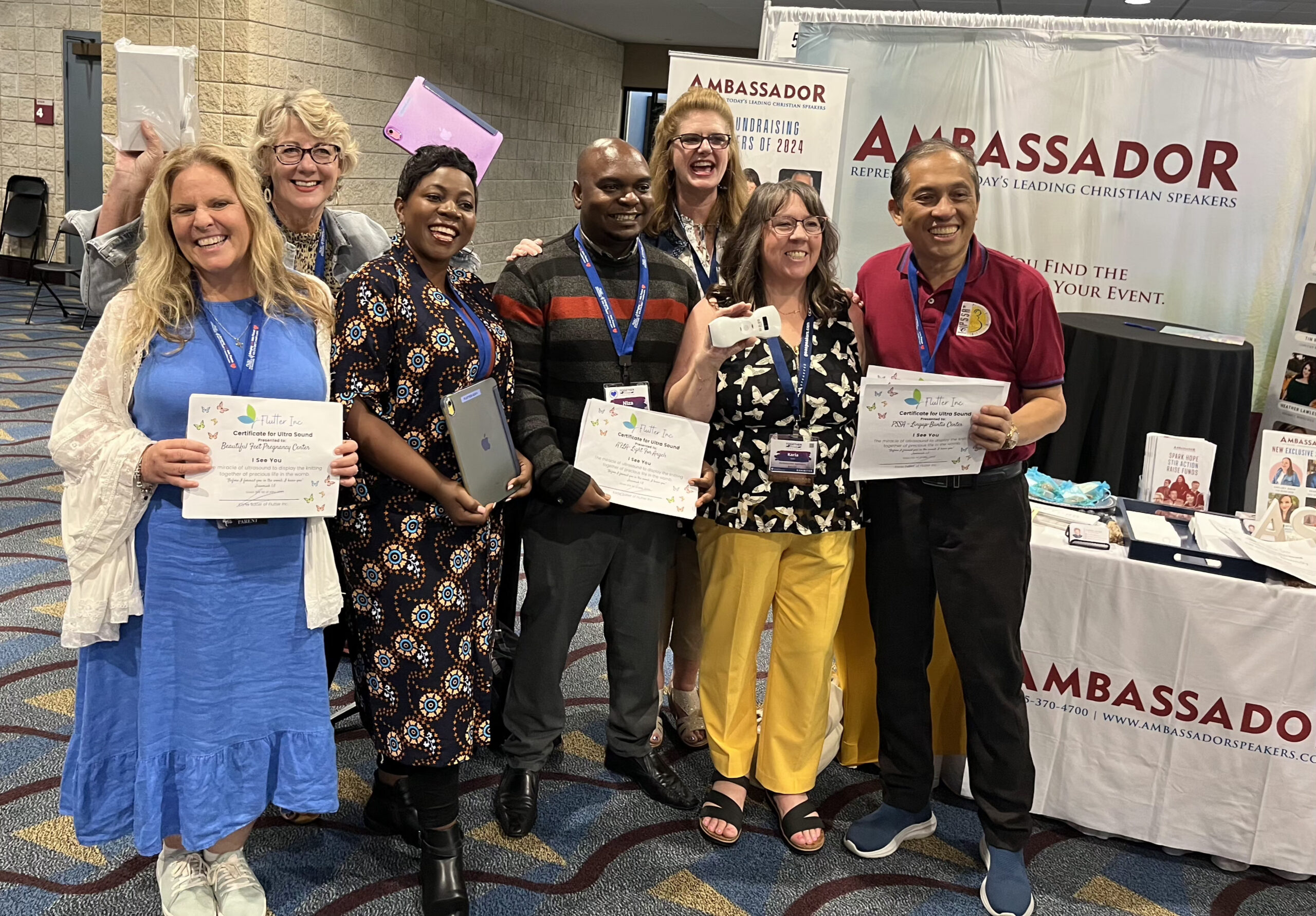 Group of ultrasound training graduates holding certificates at a pregnancy center conference